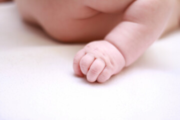 face of a little newborn boy close-up cheeks round face