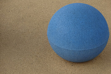 Close up of a light blue color ball on yellow textured background. Reidi street, Tallinn, Estonia