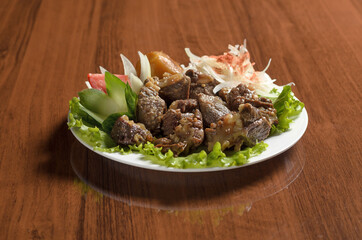 Asian cuisine Uzbek food pieces of stewed delicious lamb and beef in a white plate on the table