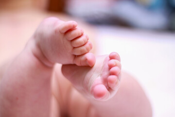 face of a little newborn boy close-up cheeks round face