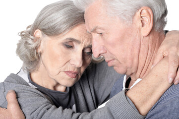 Portrait of sad senior couple isolated on white background