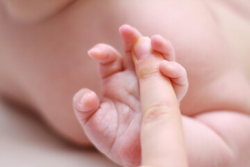 Obraz na płótnie Canvas face of a little newborn boy close-up cheeks round face