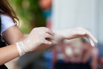 Obraz na płótnie Canvas woman wearing rubber gloves to prevent germs.