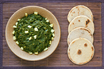 Mustard greens dish with corn roti flatbreads. Vegan Indian meal (Makki di roti with sarson ka saag).