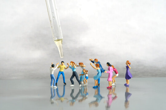 Miniature people toy figure photography. Group of people jostling for vaccine