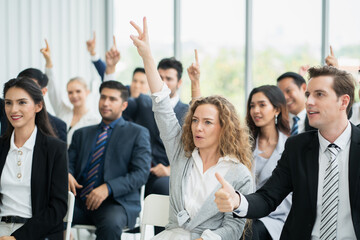 group of business people workshop training in business event at seminar room. business people rasing hands up