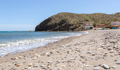 view of the beach next to fishermen's houses and boats