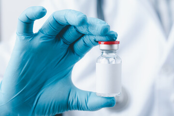 doctor, nurse, scientist hand wear blue gloves holding bottle vaccine, preparing for child, baby,...