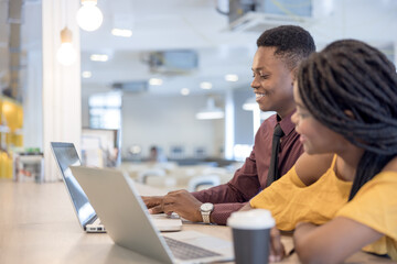 african college university students using laptop together .