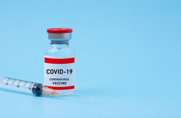 Coronavirus covid-19 vaccine  and Syringe  on copy space blue background,flu,  measles, medicine and drug concept