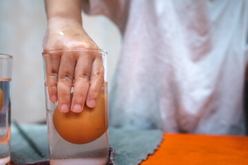 Science Experiment on Sinking Eggs - Floating eggs with water and salt water. Child's hand was...