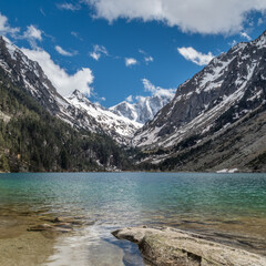 View of Lac de Gaube with turquoise water and snowy mountains in background, Cauterets, Pond d'Espagne, France