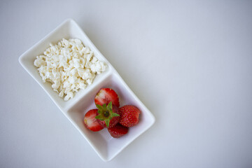 cottage cheese and strawberries on a white background