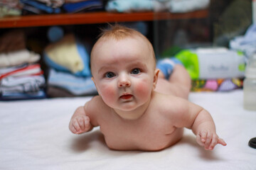 face of a little newborn boy close-up cheeks round face