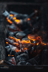 Burning coals in the grill before cooking
