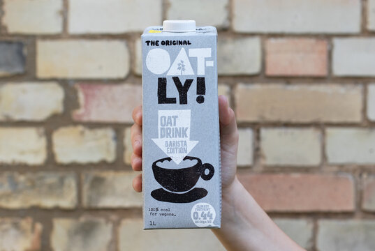 London / UK - August 24th 2019 - Hand Holding An Oatly Milk Carton. Oatly Is A Dairy Free Vegan Milk Alternative.