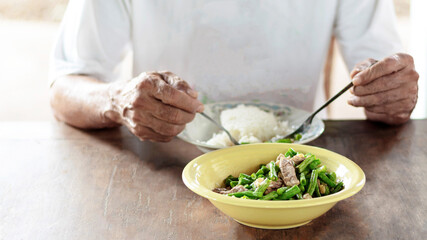 Fried beans with pork in a yellow bowl on the dining table