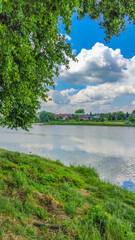 Fototapeta na wymiar Landscape with a lake and clouds in the sky in the summer season