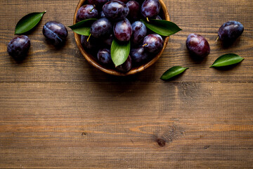 Purple plums in bowl. Plum harvest top view