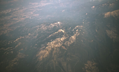 Fototapeta na wymiar panoramic asian mountains view at sunrise from plane