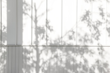 Shadow of tree branches on white wooden slats