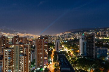 Fototapeta na wymiar Medellin, Antioquia, Colombia. December 21, 2020: Night urban landscape with buildings in El Poblado.