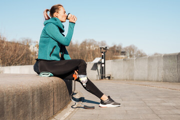 Young healthy sportswoman with prosthetic leg