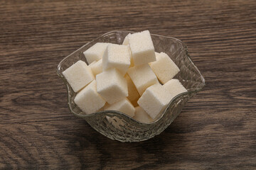 Refined white sugar cubs in the bowl