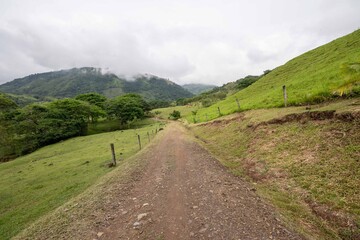 Rural landscape with road to the farm and cloudy sky. Antioquia, Colombia.