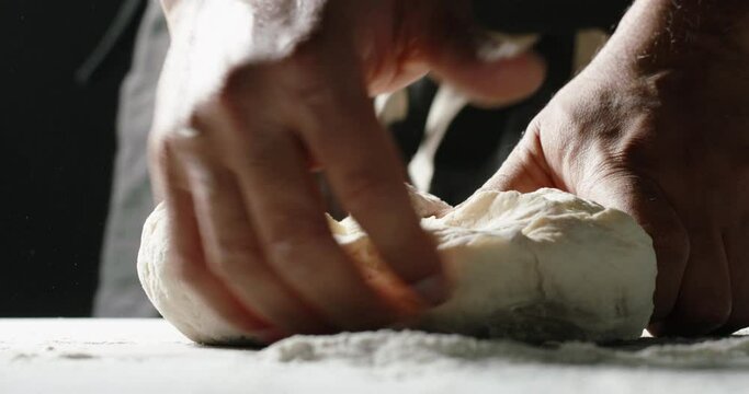 Hands of professional baker kneading dough. Chef carefully making bread with traditional recipe food and drink close up 4k footage