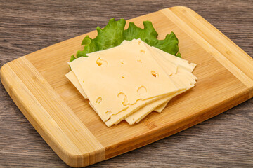 Sliced yellow cheese over board