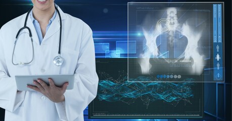 Mid section of female doctor using digital tablet against medical data processing on blue background