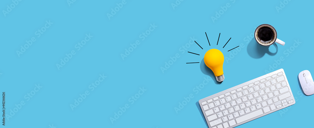 Wall mural Computer keyboard with a yellow light bulb