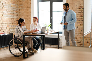 Three colleagues working together in office