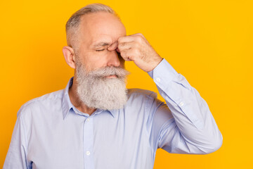 Portrait of attractive depressed sullen sick man feeling bad touching nose isolated over gray pastel color background