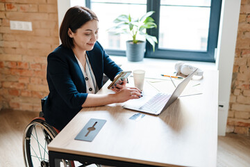 Young disabled business woman in wheelchair working