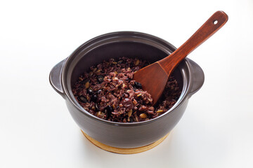 Nutritious hot stone pot rice with mushroom, miscellaneous cereals, jujube, and pine nut. Isolated on white background.
