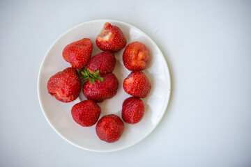 strawberries in a plate on a white background