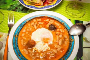 traditional Spanish Fabada asturiana. white bean stew with egg