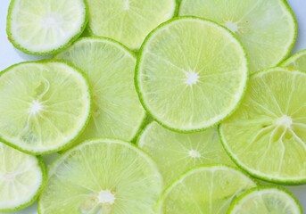 fresh green lemon of lime slices on the background