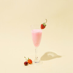 Summer strawberry and cherry shake. On a nude background. Minimal aesthetics.