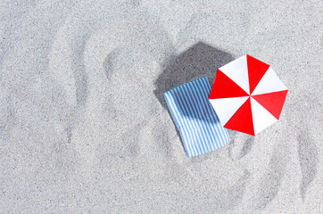 Fototapeta na wymiar Summer Background. Sand, beach umbrella, sun lounger