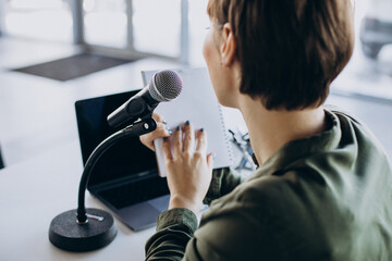Young woman recording voice acting at studio