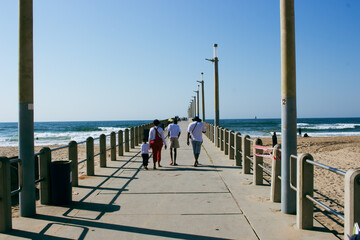 Families walking on a pier at the seaside ocean front. Durban, South Africa