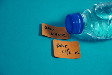 water bottle and written save water save life notes