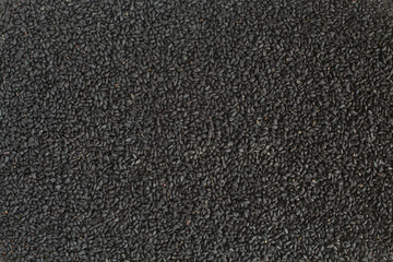 Background full of black cumin. Nigella sativa seasoning texture