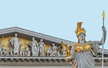 Obraz premium Athena statue at fountain (Pallas-Athene-Brunnen) in front of the Parliament, an ancient Greek goddess for victory and warfare at blue sky in Vienna, Austria, details, closeup.