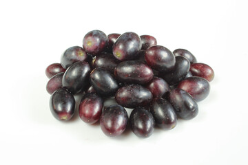 Pile of dark grapes isolated on white background. 