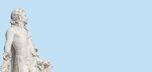 Obraz premium Banner with Mozart monument in historical downtown of Vienna, Austria at sunny day, blue sky with copy space for text, details