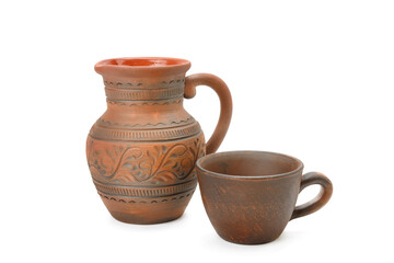 Clay jug and mug isolated on white .